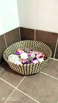 a basket filled with flowers on a bathroom floor at M&K house in Rhodes Town