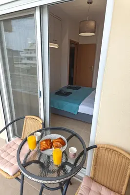 a table with a bowl of food and two cups of orange juice at M&K house in Rhodes Town