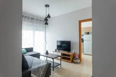 a living room with a couch and a table at M&K house in Rhodes Town