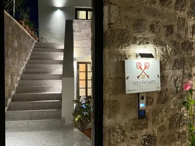 a sign on the side of a building with stairs at Vetus Vicinato Luxury Homes in Rhodes Town