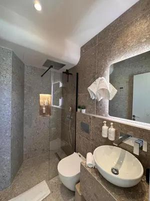 a bathroom with a sink and a toilet and a shower at Vetus Vicinato Luxury Homes in Rhodes Town