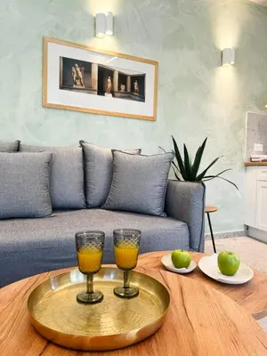 a living room with a table with two glasses on it at Vetus Vicinato Luxury Homes in Rhodes Town