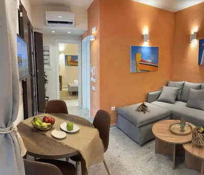 a living room with a table and a couch at Vetus Vicinato Luxury Homes in Rhodes Town