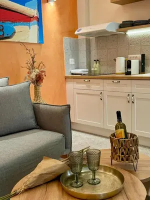 a living room with a couch and a table with wine glasses at Vetus Vicinato Luxury Homes in Rhodes Town