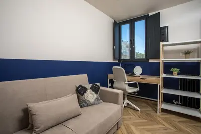 a living room with a couch and a desk at Villa Lou in Rhodes Town