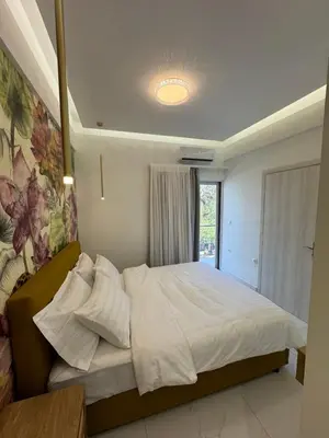 a bedroom with a large white bed with a window at Cozy City Center Apartment B in Rhodes Town
