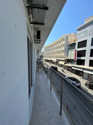 a balcony of a building with a view of a street at Cozy City Center Apartment B in Rhodes Town