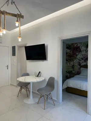 a room with a table and two chairs and a bed at Cozy City Center Apartment B in Rhodes Town
