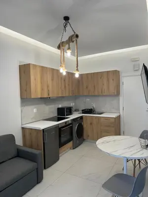 a kitchen with a couch and a table in a room at Cozy City Center Apartment B in Rhodes Town