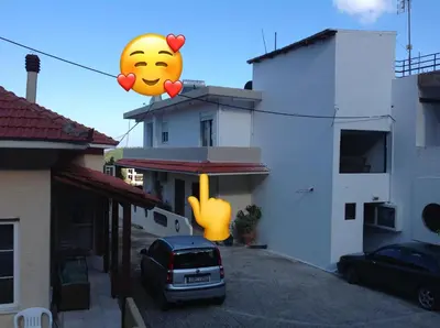 a large smiley face balloon in a parking lot at Casa Marina in Archipolis