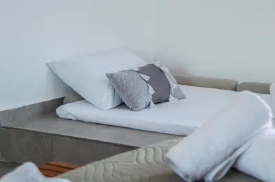 a couch with pillows on top of it at Anasa Rustic Villa in Kolimbia