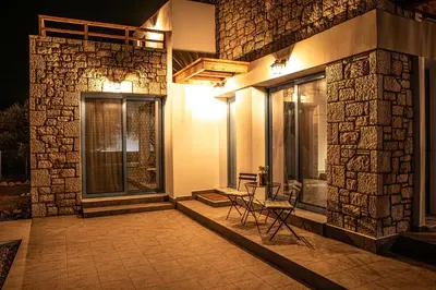 a patio with a table and chairs next to a building at Anasa Rustic Villa in Kolimbia