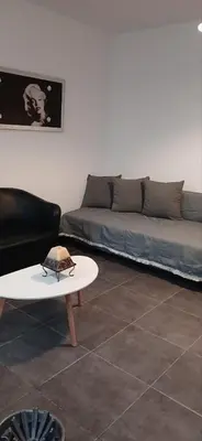 a living room with a couch and a table at Tsampikas House in Faliraki