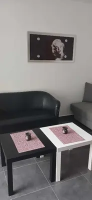 a living room with a coffee table and a couch at Tsampikas House in Faliraki