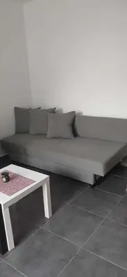 a large couch in a room with a table at Tsampikas House in Faliraki