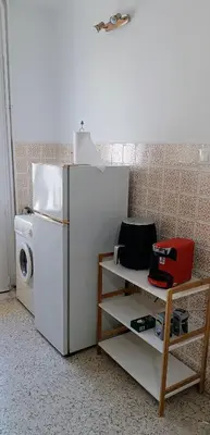 a kitchen with a refrigerator and a washing machine at Pap's House in Rhodes Town