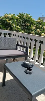 a bench and a table with a hat on it at Pap's House in Rhodes Town