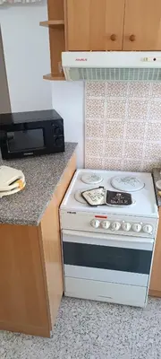 a kitchen with a white stove and a microwave at Pap's House in Rhodes Town