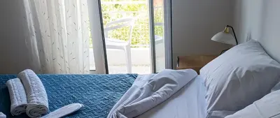 a bedroom with a bed with two remote controls on it at Pap's House in Rhodes Town