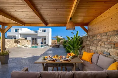 a patio with a table with food on it at Amora Pool Villas in Gennadi