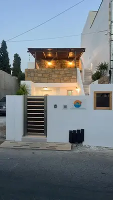 a white house with a gate in front of it at Villa Chris - Malona in Malona Village