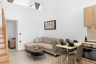 a living room with a couch and a table and chairs at Villa Chris - Malona in Malona Village