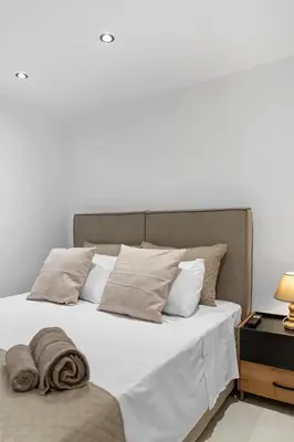 a bed with white sheets and pillows in a bedroom at Villa Chris - Malona in Malona Village