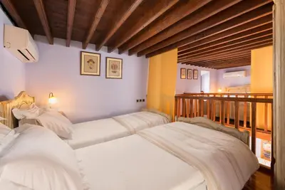 two beds in a room with white sheets at Residenza Maria Lindos Villa in Líndos