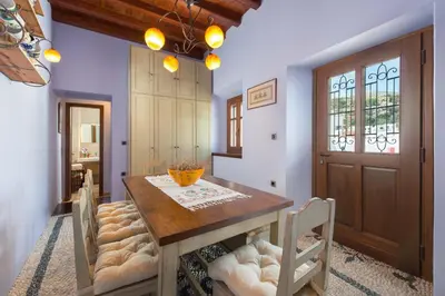 a dining room with a wooden table and chairs at Residenza Maria Lindos Villa in Líndos