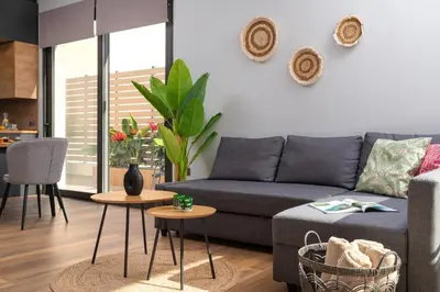 a living room with a couch and a table at La Siesta Villas in Ixia