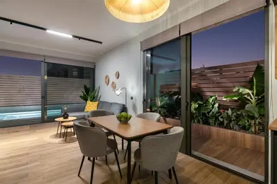 a dining room with a table and chairs at La Siesta Villas in Ixia