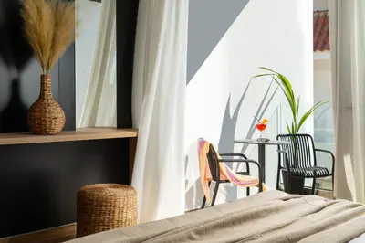 a bedroom with a table and chairs and a window at La Siesta Villas in Ixia