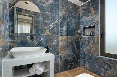 a bathroom with a sink and a mirror at La Siesta Villas in Ixia