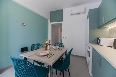 a dining room with a table and chairs in a kitchen at Antonis Studio in Archangelos
