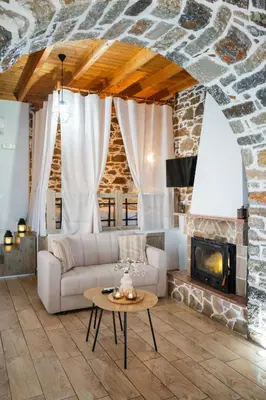 a living room with a couch and a fireplace at Marianthi's House in Émbonas