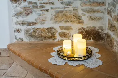 a table with two candles on top of it at Marianthi's House in Émbonas