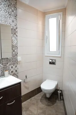 a white bathroom with a toilet and a window at Marianthi's House in Émbonas