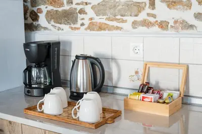 a kitchen counter with a coffeemaker and a coffee maker at Marianthi's House in Émbonas