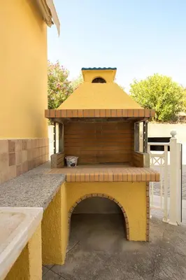a brick oven with a roof on a patio at Le Petit Refuge 2 Floor Maisonette with Seaview in Archangelos