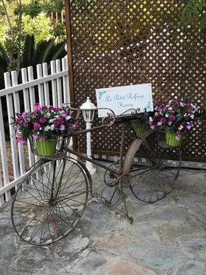 a bike with a sign on it with flowers at Le Petit Refuge 2 Floor Maisonette with Seaview in Archangelos