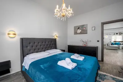 a bedroom with a bed with two white towels on it at Emerald City Apartment in Rhodes Town