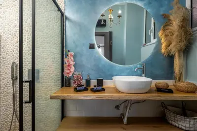 a bathroom with a sink and a mirror at Emerald City Apartment in Rhodes Town