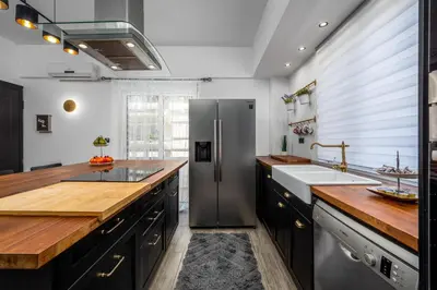 a kitchen with a stainless steel refrigerator and a sink at Emerald City Apartment in Rhodes Town