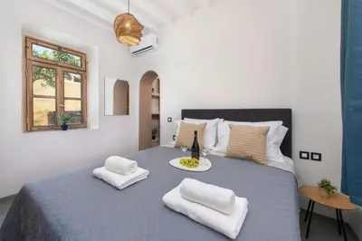 a bedroom with a large bed with two white towels at 3-4 Bedrooms Villa in old Town in Rhodes Town