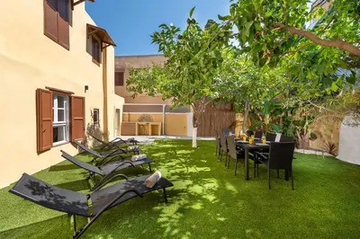 a group of chairs and a table in a yard at 3-4 Bedrooms Villa in old Town in Rhodes Town