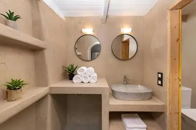 a bathroom with a sink and two mirrors at 3-4 Bedrooms Villa in old Town in Rhodes Town