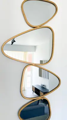 a pair of mirrors on a wall with a table at Mairyloy city luxury apartment in Rhodes Town
