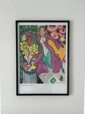 a painting of a woman sitting on a table with a bowl of fruit at Mairyloy city luxury apartment in Rhodes Town