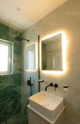a bathroom with a sink and a shower at Mairyloy city luxury apartment in Rhodes Town