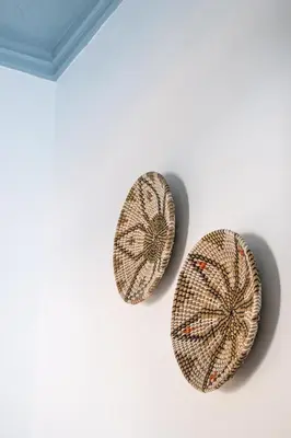 two pieces of art on a white wall at Duchess Harbour View in Symi